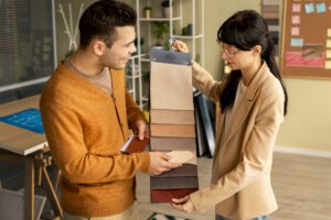 Two people discussing packaging samples in a retail environment, illustrating customer engagement and consultation with Singapore packaging companies.