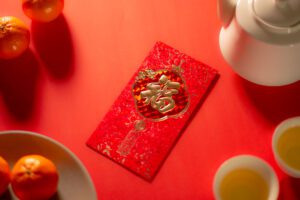 prosperity and spring.chinese new year and lunar new year celebrations red envelope orange and hot tea.